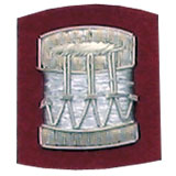 Embroidered silver wire on red cloth drum insignia badge