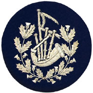Embroidered silver wire on navy blue cloth wreathed bagpipes Pipe Major insignia badge