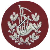 Embroidered silver wire on red cloth wreathed bagpipes Pipe Major insignia badge